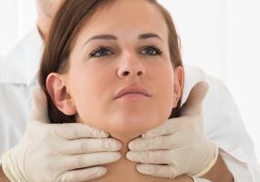 Doc_Examining_Womans_Thyroid